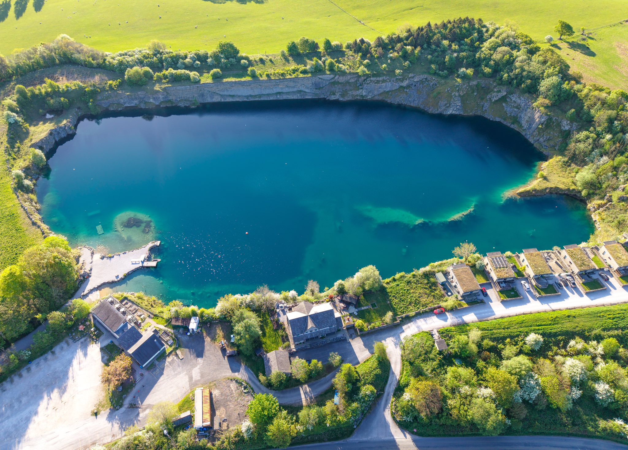 Divers entering Capernwray Quarry with clear blue water